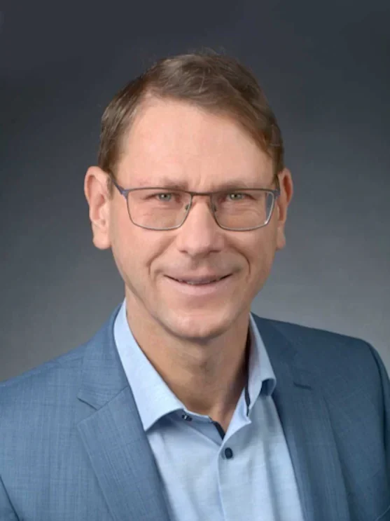 Fachanwalt für Insolvenzrecht Karsten Kruschel Rechtsanwalt für Insolvenzrecht Karsten Kruschel: mit Brille und Anzug und Hemd, lächelt freundlich vor grauem Hintergrund.